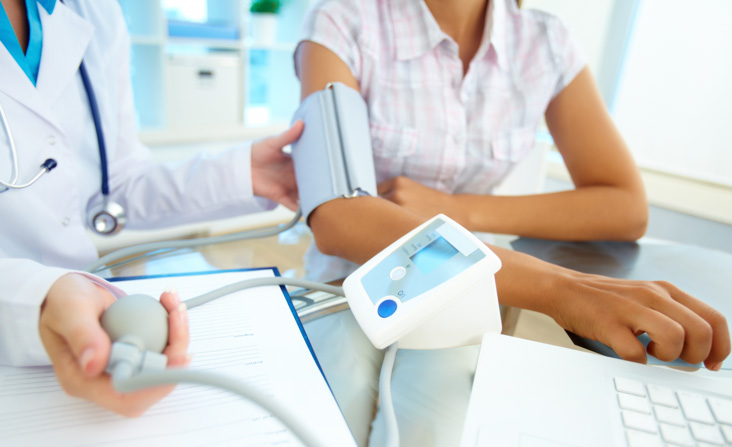 doctor taking blood pressure test of a patient