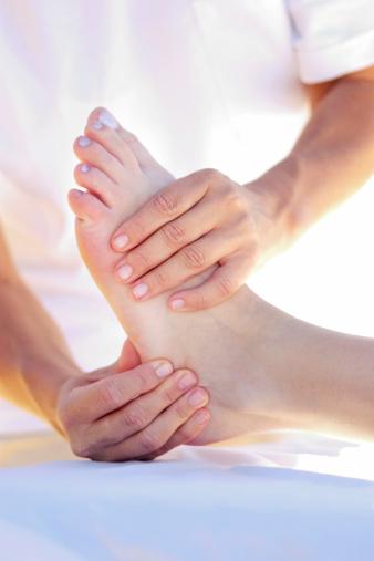 a foot being treated by hands