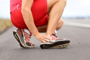 a jogger adjusting their running shoe